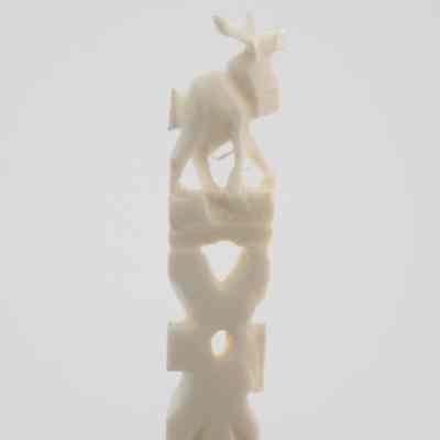 The end of one of the skewers.: Up close image of the end of one of the skewers. It depicts an elk.