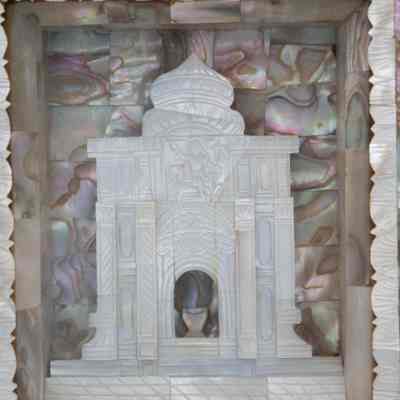 Middle of the Mother of Pearl and olive wood Hindu temple scene shadow box.: Up close image of the center of the Mother of Pearl and olive wood picture shadow box. The middle of the frame contains an onion-domed church with a basin.