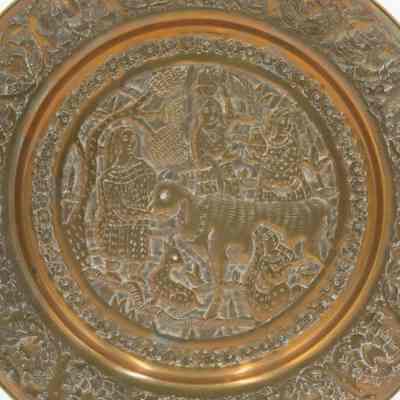 Close-up of the plate: A close-up image of the medium brass plate with embossing of 4 women surrounding a cow and a small animal.