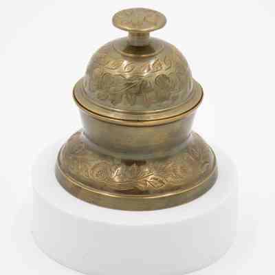 Meditation bell: A brass meditation bell set with intricate leaf designs.