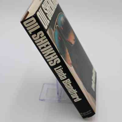Spine of "Oil Sheikhs": The spine is solid black with the title, author and publisher in horizontal, bold, white text.