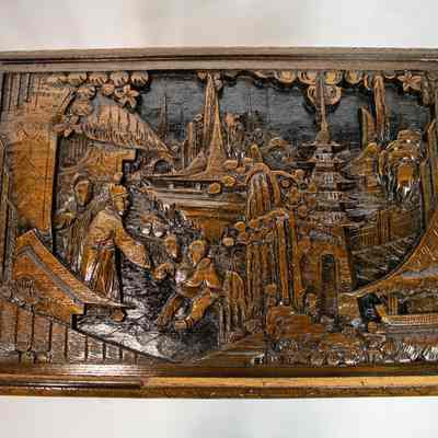 Hong Kong nesting table top: The image shows a finely carved wooden nesting table from Hong Kong with intricate designs, featuring traditional scenes under a glass top.