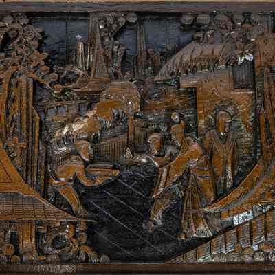 Hong Kong nesting table top: The image shows an intricately carved wooden tabletop, depicting a scene with figures in traditional attire amidst a detailed landscape.