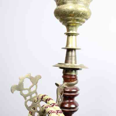 Bubble pipe hoses: The image shows a traditional hookah with ornate brass detailing and woven hoses attached.