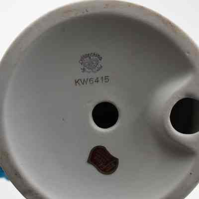 Bottom of second figure: The round white base has a printed logo, "Lefton China; Hand Painted," and "Lefton; trade mark; exclusives Japan." It has an item number, "KW6415."