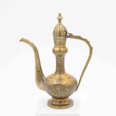 Brass ewer: The image features a single intricately engraved brass aftaba ewer with a curved spout and handle.