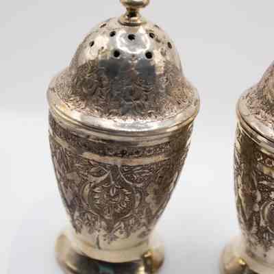 One of the Persian silver salt and pepper shakers.: Image of one of the two salt and pepper shakers debossed with a floral leaf design.