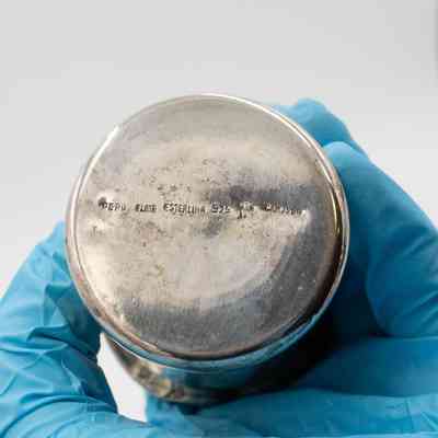 Bottom of Silver Cup: Close up image of the bottom of the silver cup. Engraved into the bottom is "Peru Flair Esterlina 925 Camusso"