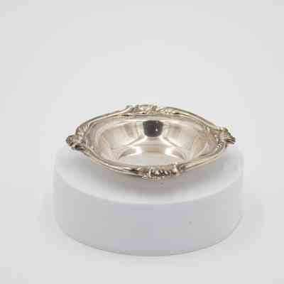 Silver Saucer: Image of the silver saucer. The saucer has a scroll finish on its edges.