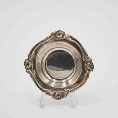 Inside of the Silver Saucer: Image of the silver saucer's interior. The plate is on a plastic stand and its interior has a simple silver finish.