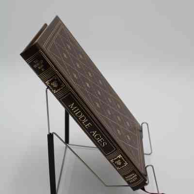Book Spine: The spine of “Middle Ages” is portioned off into 5 sections. The first section has the subtitle "The Story of Man III", the second and fourth sections contain regal ornaments, the third is the title, and the fifth is for the creator, National Geographic Society. All of the details are colored gold.
