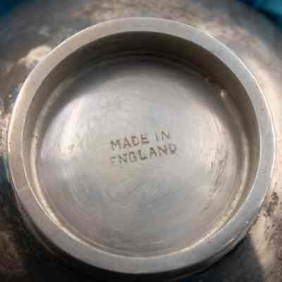 Bottom of the small silver trophy cup presented to the Jordans by the Caledonian Society.: Up close image of the bottom of the silver trophy cup stamped with "MADE IN ENGLAND."