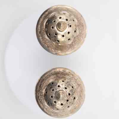 Top of the pair of Persian silver salt and pepper shakers.: Image of the tops of both silver salt and pepper shakers.