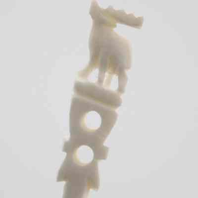 The end of one of the skewers.: Up close image of the end of one of the skewers. It depicts an elk.