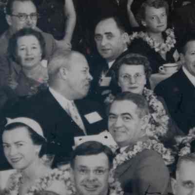 Leland and Leslie: Close-up image of Leland and Leslie at the Graduation Banquet. Leland is wearing a suit and Leslie is wearing a floral lei.