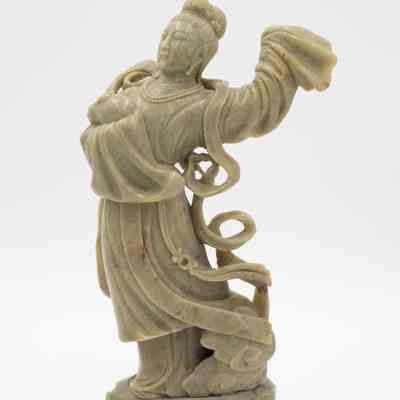 One of the large carved soapstone figurines on a carved base from Bali.: Image of one of two of the carved soapstone figurines. This one depicts a woman dancing.