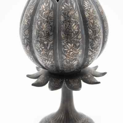 Burnished metal stemmed tulip-shaped vase.: Up close image of the burnished metal tulip-shaped stemmed vase with engraved flower motifs.