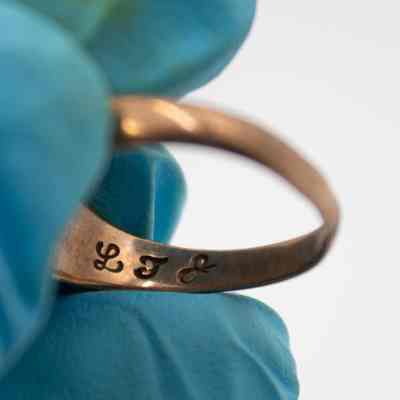 Inside L.T. Jordan's Floresville High School 1923 class ring.: Image of L.T. Jordan's initials debossed on the inside of his 1923 Floresville High School class ring.