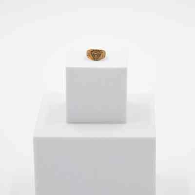 Jessie Wright Jordan's Lufkin High School 1925 class ring.: Image of Jessie's ring sitting on a white block. It is gold. There is a panther head in the center and "L.H.S" around the center.