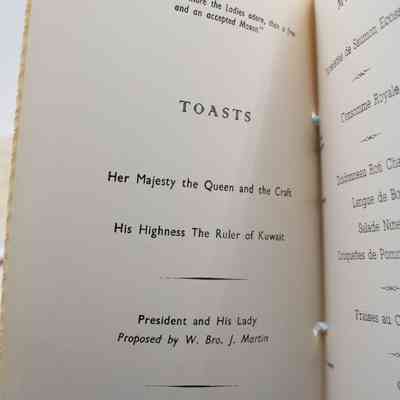 Inside the program from a Ladies' Night at the Rowland Chadwick Masonic Lodge, showing the toasts page.: Up close image of the toasts to be had at the Ladies' Night. The inside of the program is off-white with black text. There is a quote at the top of the page, "No mortal can more the Ladies adore, than a free and accepted Mason." Under the quote, it lists the "TOASTS" to be done that night, "Her Majesty the Queen and the Craft," "His Highness The Ruler of Kuwait," "President and His Lady Proposed by W. Bro. J. Martin," and "THE LADIES." "THE LADIES" were "Proposed by ... ... Bro. E.J. Gowan," with a "Reply ... ... Mrs. R. Edge."