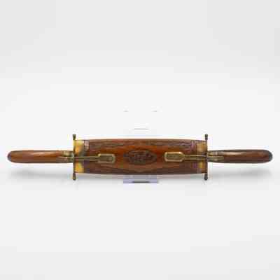 Carving set: A wooden double scabbard case intricately holds both a carving knife and fork securely inside.