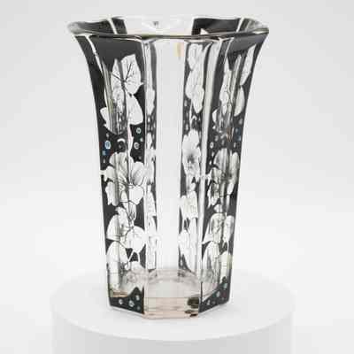 Handblown glass vase with flower and leaf design.: Image of the handblown glass vase with black flowers and leaves and blue dots. There is a faint gold line running down four of the sides.