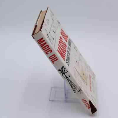 Spine of "Magic Oil": The spine of "Magic Oil" has the title and author, it also includes a graphic of an oil rig.