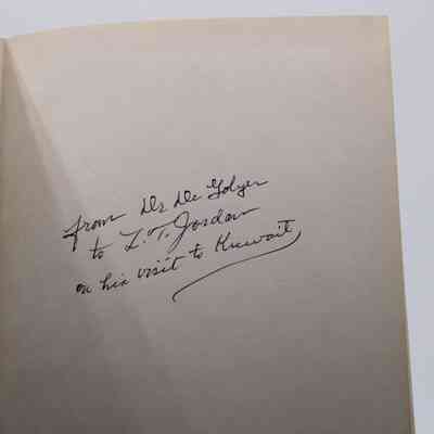 Handwritten note inside cover: Black cursive handwriting, "to L.T. Jordan on his visit to Kuwait."