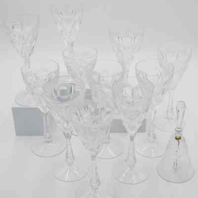 Set of matching crystal wine glasses and bell: The image showcases a set of matching crystal wine glasses and the crystal cut dinner bell.