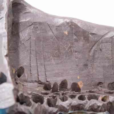 Bottom of one of the stone-carved Shoushan villages.: Up close image of the bottom of one of the carved villages. It is dark brown and there is a number scratched into the bottom, "925."
