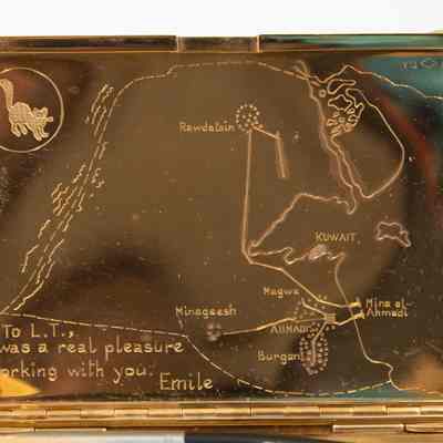 Engraved map: The gold cigarette case features Kuwait's map, engraved inside, including an engraved message, "To L.T., It was a real pleasure working with you, Emile"