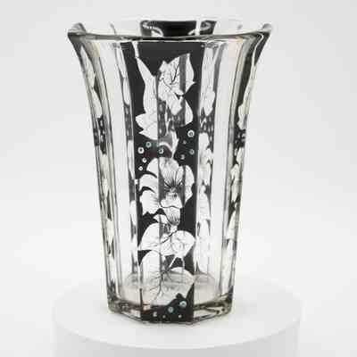 Handblown glass vase with flower and leaf design.: Image of the handblown glass vase with black flowers and leaves and blue dots. There is a faint gold line running down four of the sides.