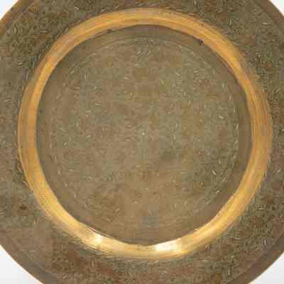 Brass lotus plate: A brass plate with small engravings of lotus' covering the entire plate.