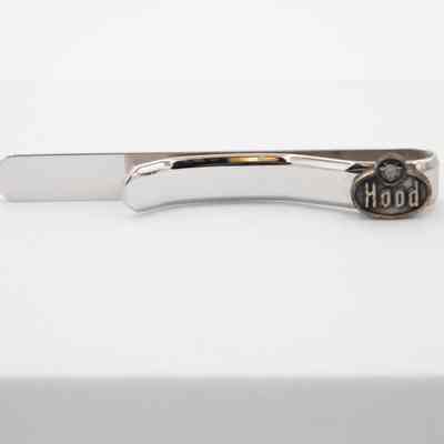 "Hood" tie bar: A silver "Hood AMP 26th" tie bar. Has a large "Hood" emblem decorating the solid silver tie bar.