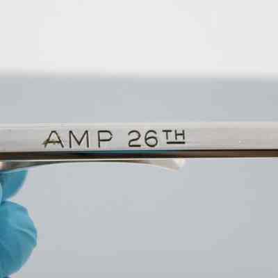 Engraving in back of tie bar: "AMP 26th" engraved into the back of the tie bar.