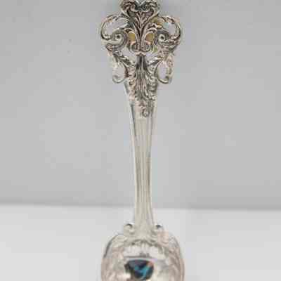 One of the plated silver teaspoons.: Up close image of one of the silver plated teaspoons. It is intricately decorated with swirls and leaves.
