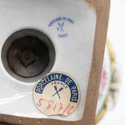 Bottom of tureen: The bottom of the tureen is white, it has a printed on logo, and a sticker. The logo says "Porcelaine de Paris; France" and has two crossed arrows. The sticker has the same text and logo, as well as a hand-written, "5817/2."