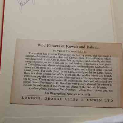 Close up of Note about Violet Dickson.: A printed card stuck in the cover, "Wild Flowers of Kuwait and Bahrain by Violet Dickson, M.B.E. The author has lived in Kuwait for the last 24 years, and has made a careful collection of all the plants of Kuwait State. Her collection, which was described in the Kew Bulletin No. 3, 1949 is undoubtedly the most comprehensive yet made for this part of Arabia. It includes a new genus of Cruciferae, several new species and plants not listed from Arabia before, many plants from Central and Eastern Arabia, and a list of some Trucial Coast plants. For each plant, listed alphabetically under its Latin name, there is a short description of the plant and the locality where it is found, written in popular style to make identification of the specimen easier for the layman. There are numerous illustrations in black and white and two colour plates. Professor R. O. Good has very kindly allowed the author to include his collection of the Plants and Algae of the Bahrain Islands."