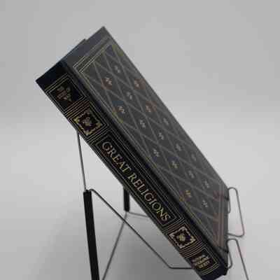 Book Spine: The spine of “Great Religions” is portioned off into 5 sections. The first section has the subtitle "The Story of Man V", the second and fourth sections contain regal ornaments, the third is the title, and the fifth is for the creator, National Geographic Society. All of the details are colored gold.