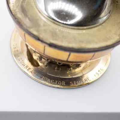 Engravings around base of lighter: "The Dounreay Reactor Sphere, 1956."