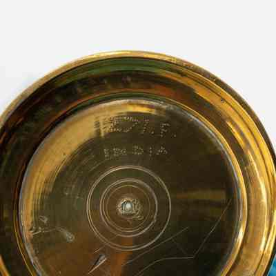 Bottom of skinny brass vase: Bottom of skinny brass vase has "Made in India."