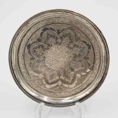 One of the six round Persian silver dishes engraved with floral mandala design.: Image of one of the round Persian silver dished engraved with a floral mandala design.