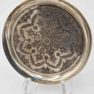 One of the six round Persian silver dishes engraved with floral mandala design.: Image of one of the round Persian silver dished engraved with a floral mandala design.