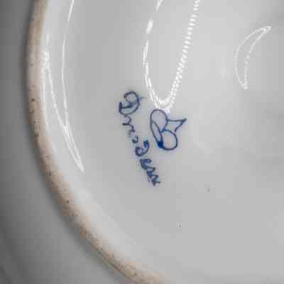 Blue logo on bottom of plate: Blue text next to a small crown logo reads, "Dresden."