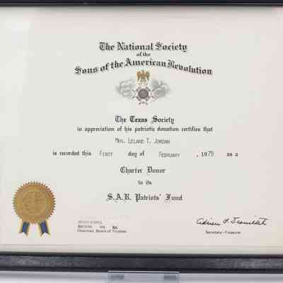 Sons of the American Revolution certificate: The image shows a framed Sons of the American Revolution certificate with gold seal.