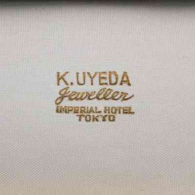 Jewelers name inside box: In gold text on white fabric, "K. Uyeda Jeweller Imperial Hotel, Tokyo."