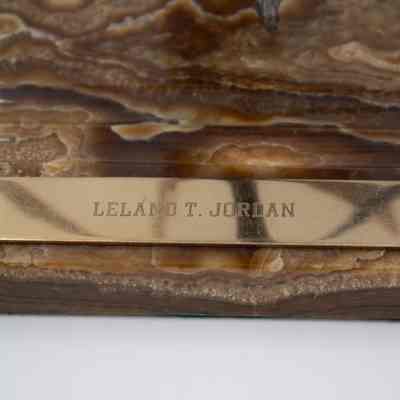 Nameplate: A metallic plaque displays the name "LELAND T. JORDAN."