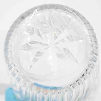 Bottom of the large crystal cut vase that belonged to the Jordans.: Up close image of the bottom of the crystal cut vase. There is an eight-point star on the bottom.