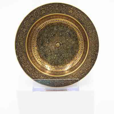 Brass ashtrays with designs: A brass ashtray showcases intricate black floral motifs, elegantly designed on its surface.