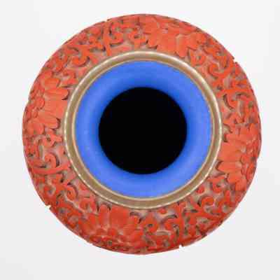 Interior of cinnabar vase: The image shows a detailed red cinnabar vase with a blue interior.